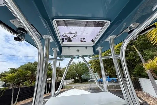 Slide: The Image of 2025 Contender 26 Bay boat with sleek design and sturdy metal framework. - 10