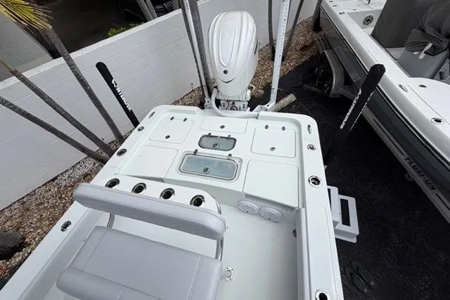 Slide: The Image of 2025 Contender 26 Bay boat deck with seating and storage compartments. - 15