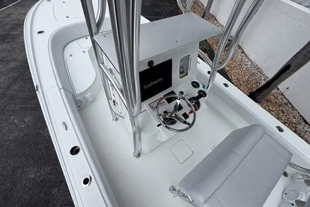 Slide: The Image of 2025 Contender 26 Bay boat cockpit with Garmin navigation system and sleek design. - 16