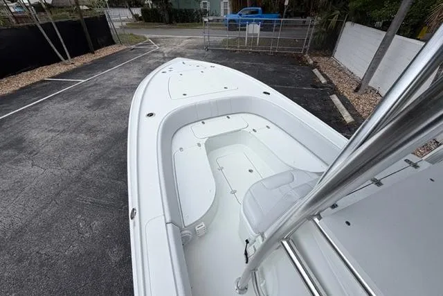 Slide: The Image of 2025 Contender 26 Bay boat with sleek white deck and seating. - 17