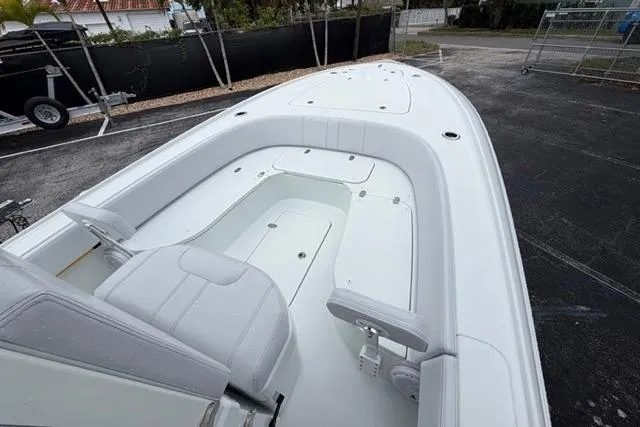 Slide: The Image of 2025 Contender 26 Bay boat interior with white seating and spacious deck. - 19