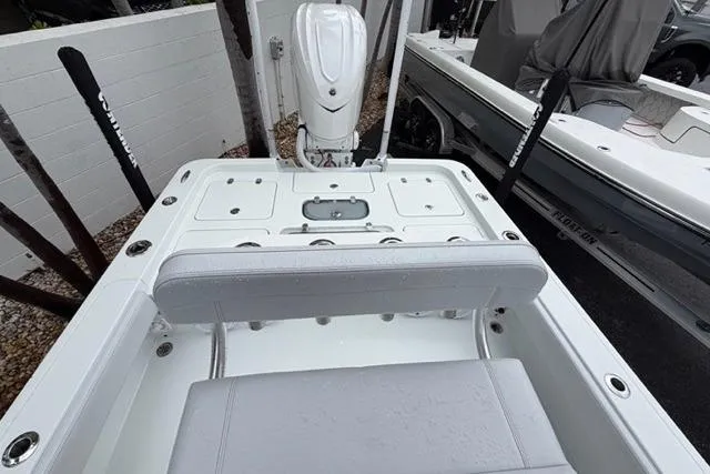 Slide: The Image of 2025 Contender 26 Bay boat interior with seating and motor, showcasing modern design. - 21