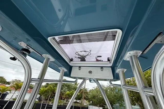 Slide: The Image of 2025 Contender 26 Bay boat interior, featuring a sleek roof hatch and sturdy metal supports. - 22
