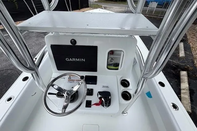 Slide: The Image of 2025 Contender 26 Bay boat console with Garmin navigation system and steering wheel. - 23