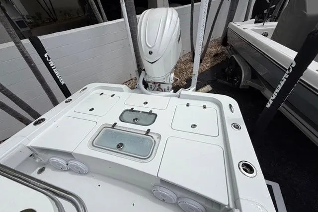 Slide: The Image of 2025 Contender 26 Bay boat deck with storage compartments and outboard motor. - 8