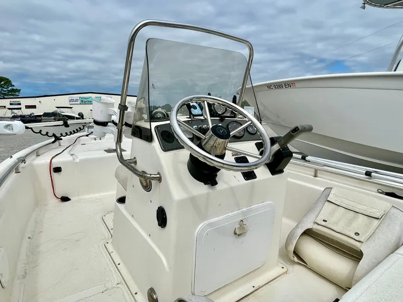 Slide: The Image of 2004 Scout Sportfish 160 boat console with steering wheel and controls. - 10