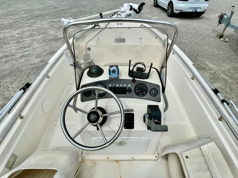 Slide: The Image of 2004 Scout Sportfish 160 helm with steering wheel and instruments. - 11