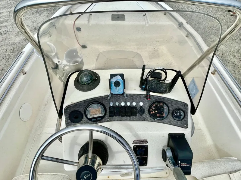 Slide: The Image of Console of a 2004 Scout Sportfish 160 boat. - 12