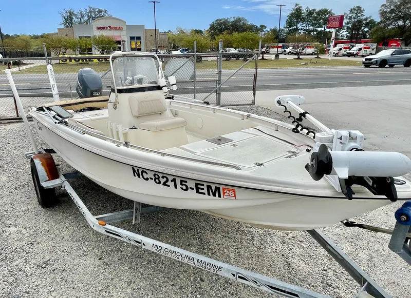 Slide: The Image of 2004 Scout Sportfish 160 boat on trailer in front of store. - 5