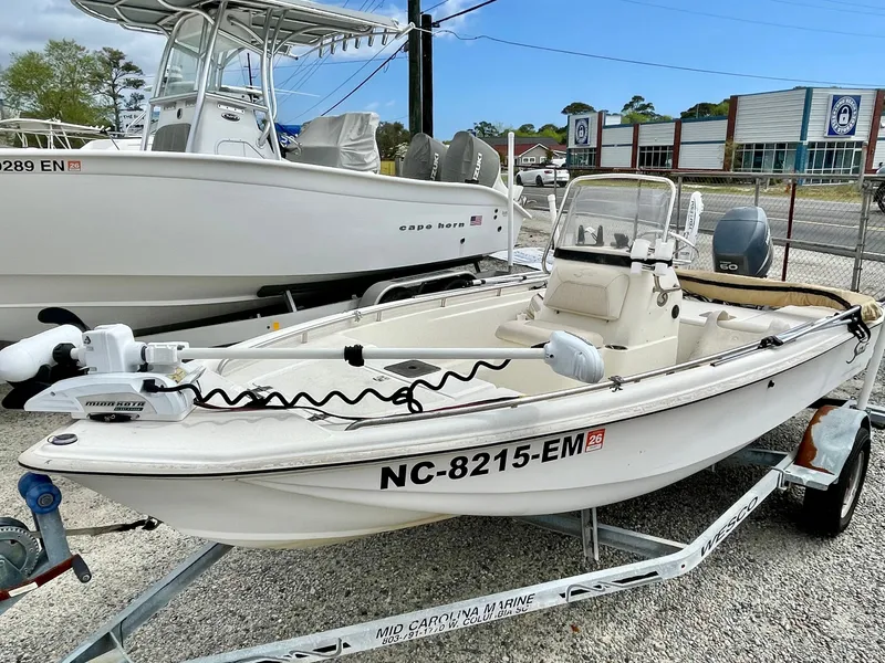 Slide: The Image of 2004 Scout Sportfish 160 boat on trailer outdoors. - 6