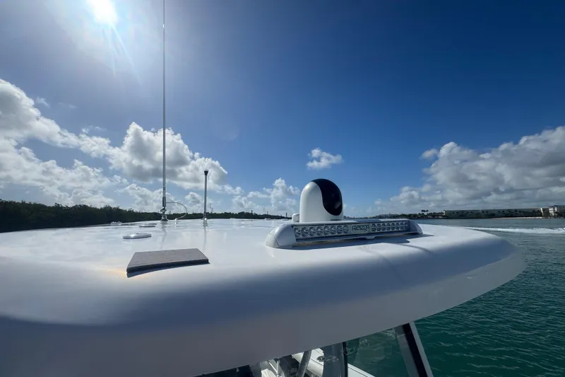 Slide: The Image of 2023 Tidewater 292 CC Adventure boat roof with radar and clear blue sky. - 12