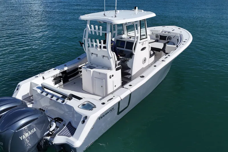 Slide: The Image of 2023 Tidewater 292 CC Adventure boat on water, featuring dual Yamaha engines. - 13