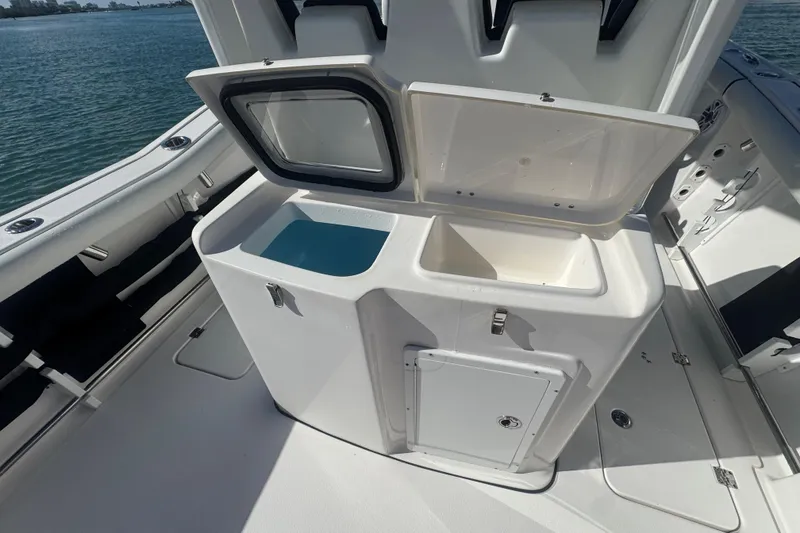 Slide: The Image of 2023 Tidewater 292 CC Adventure boat with open storage compartments on deck. - 15