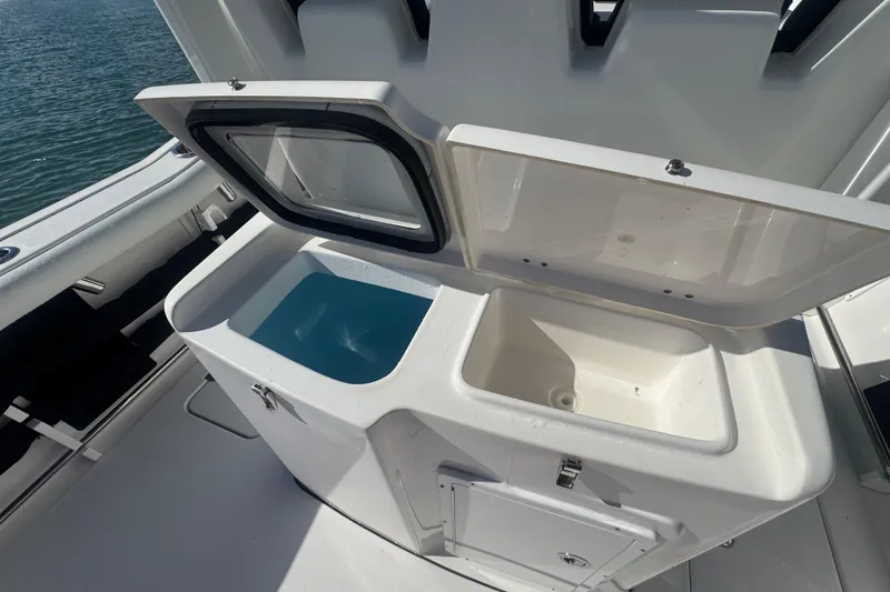Slide: The Image of 2023 Tidewater 292 CC Adventure boat with open storage compartments on deck. - 16