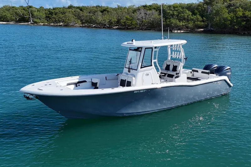 Slide: The Image of 2023 Tidewater 292 CC Adventure boat on calm blue water. - 3