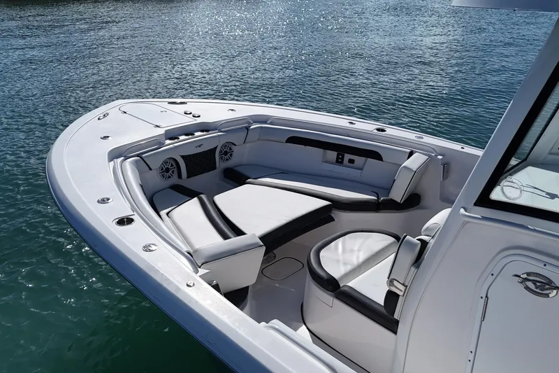 Slide: The Image of 2023 Tidewater 292 CC Adventure boat interior with luxurious seating on calm water. - 8