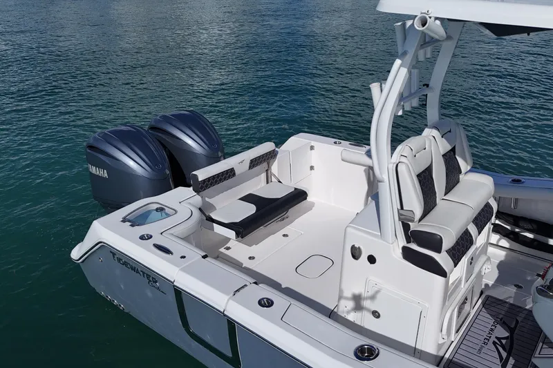 Slide: The Image of 2023 Tidewater 292 CC Adventure boat with Yamaha engines on calm water. - 9