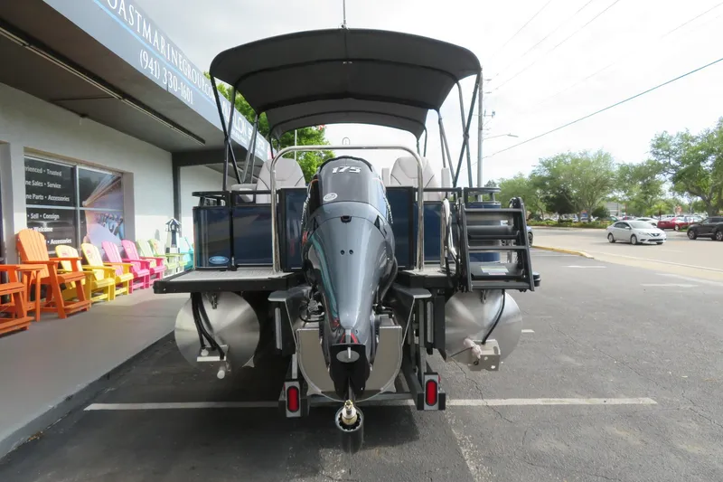 Slide: The Image of 2026 Avalon Venture 85 Rear Fish boat in parking lot. - 2