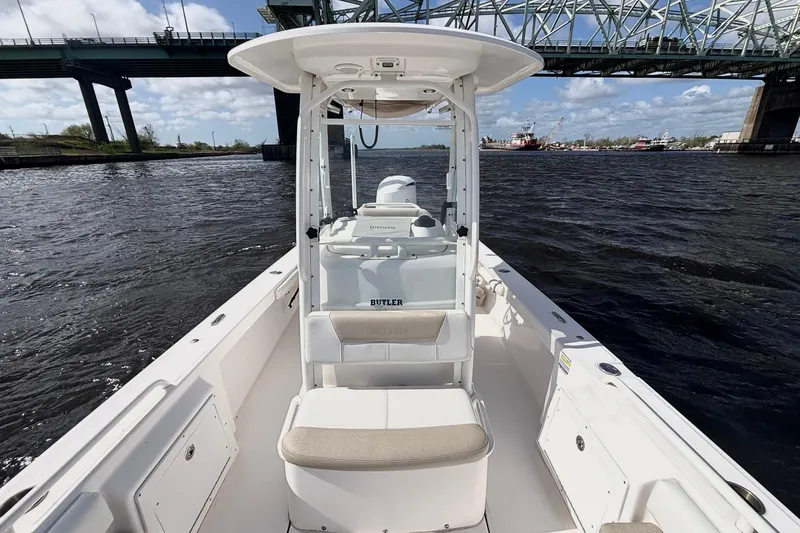 Slide: The Image of 2015 Everglades 243 Center Console boat on water under a bridge, clear sky. - 10
