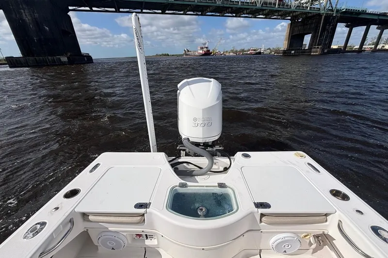 Slide: The Image of 2015 Everglades 243 Center Console boat with Yamaha 300 engine on water near bridge. - 12