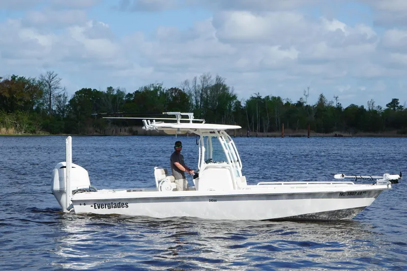 Slide: The Image of 2015 Everglades 243 Center Console boat cruising on a serene lake. - 5