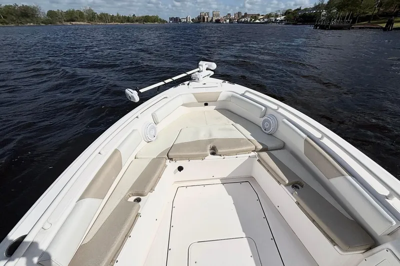 Slide: The Image of 2015 Everglades 243 Center Console boat on calm water, featuring spacious seating and modern design. - 9