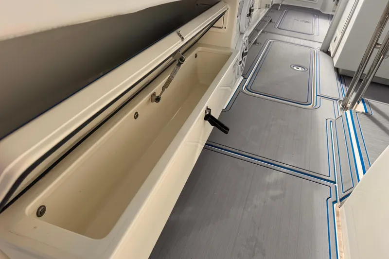 Slide: The Image of Interior view of a 2016 Hydra-Sports 4200 Siesta boat, featuring storage compartments and sleek flooring. - 27