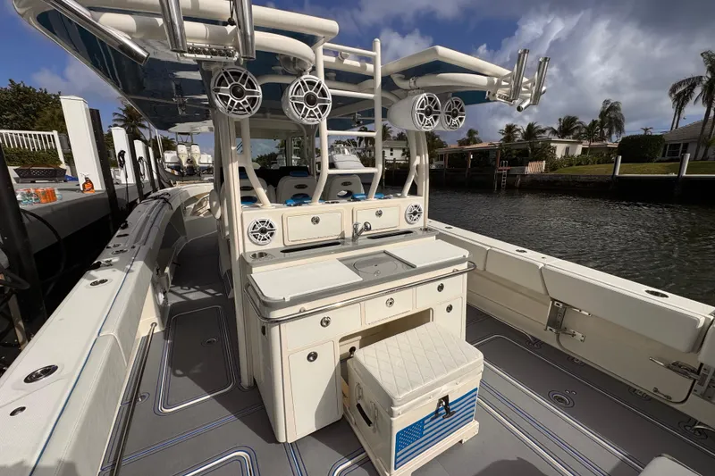 Slide: The Image of 2016 Hydra-Sports 4200 Siesta boat interior with speakers and seating, docked by waterfront homes. - 30