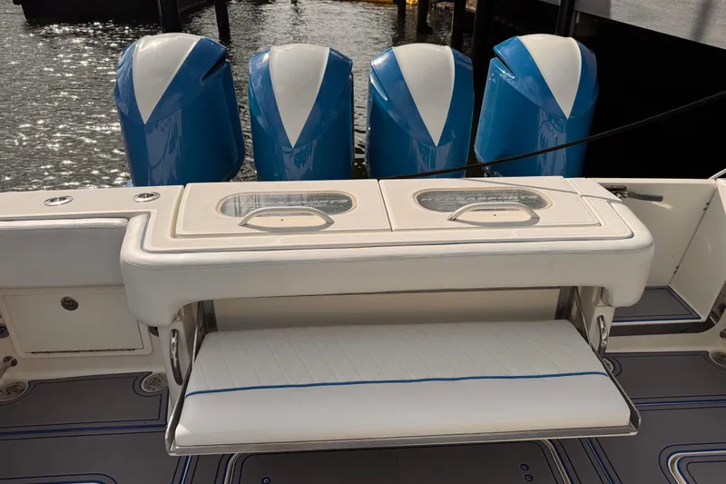 Slide: The Image of 2016 Hydra-Sports 4200 Siesta boat with four blue outboard engines and cushioned seating. - 31