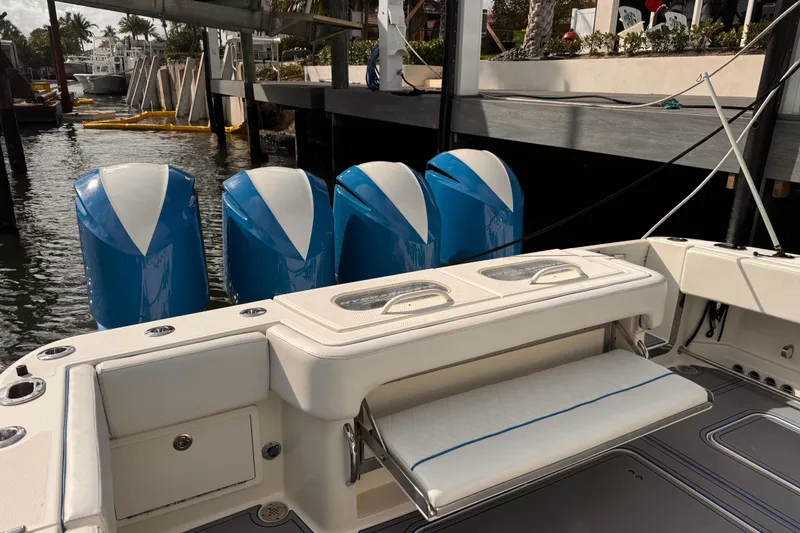 Slide: The Image of 2016 Hydra-Sports 4200 Siesta boat with four blue outboard motors docked. - 32