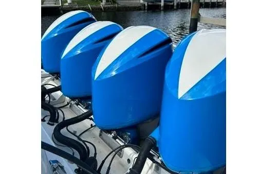 Slide: The Image of Four blue outboard motors on a 2016 Hydra-Sports 4200 Siesta boat docked by waterfront homes. - 33