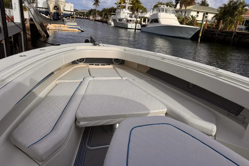 Slide: The Image of 2016 Hydra-Sports 4200 Siesta boat with spacious white seating in a marina setting. - 6