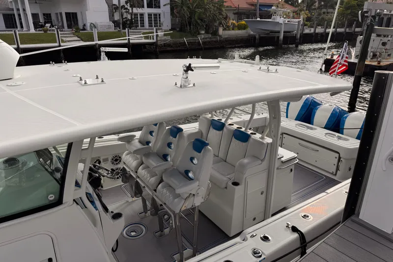 Slide: The Image of 2016 Hydra-Sports 4200 Siesta boat with luxurious seating and sleek design at a dock. - 8