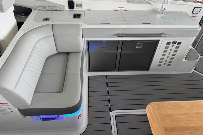 Slide: The Image of Luxurious interior of 2025 Sea Ray SLX 400 yacht with modern seating and kitchenette. - 12