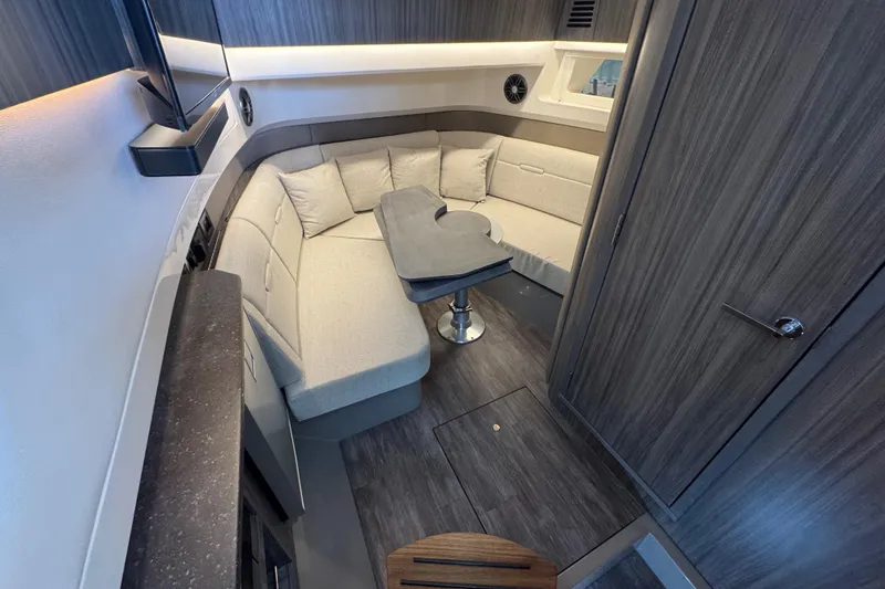 Slide: The Image of Luxurious interior of 2025 Sea Ray SLX 400 yacht with modern seating and table. - 23