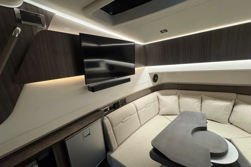 Slide: The Image of Luxurious interior of 2025 Sea Ray SLX 400 yacht with modern seating and TV. - 29