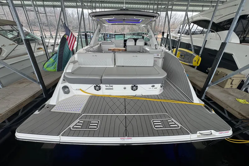 Slide: The Image of 2025 Sea Ray SLX 400 luxury boat docked, featuring spacious deck and modern design. - 3