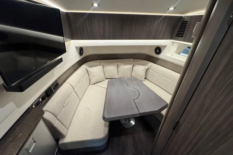 Slide: The Image of Luxurious interior of 2025 Sea Ray SLX 400 yacht with modern seating and table. - 31