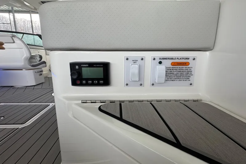 Slide: The Image of 2025 Sea Ray SLX 400 boat interior with control panel and submersible platform warning. - 33