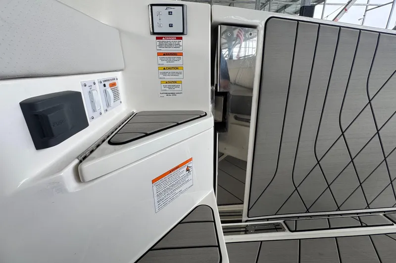 Slide: The Image of 2025 Sea Ray SLX 400 boat interior with control panel and safety warnings. - 34