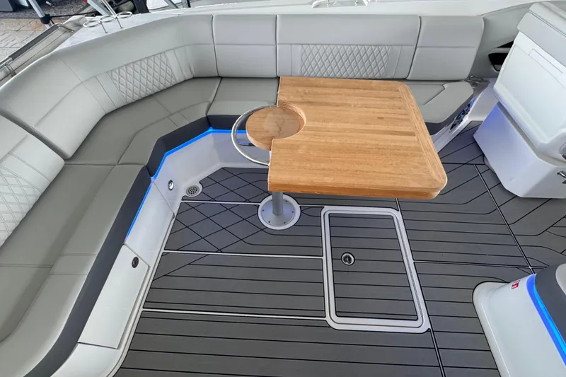 Slide: The Image of Luxurious seating area on 2025 Sea Ray SLX 400 boat with wooden table and modern design. - 9