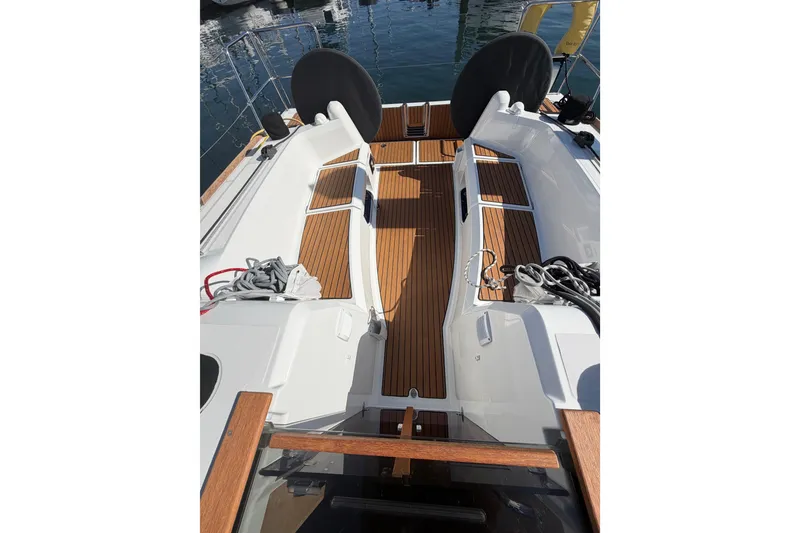Slide: The Image of 2024 Jeanneau Sun Odyssey 349 sailboat cockpit with teak flooring and dual steering wheels. - 19