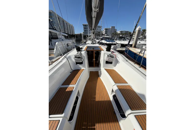 Slide: The Image of 2024 Jeanneau Sun Odyssey 349 sailboat with teak deck, docked in marina. - 21