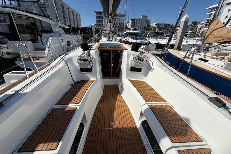 Slide: The Image of 2024 Jeanneau Sun Odyssey 349 sailboat with teak deck in marina setting. - 22