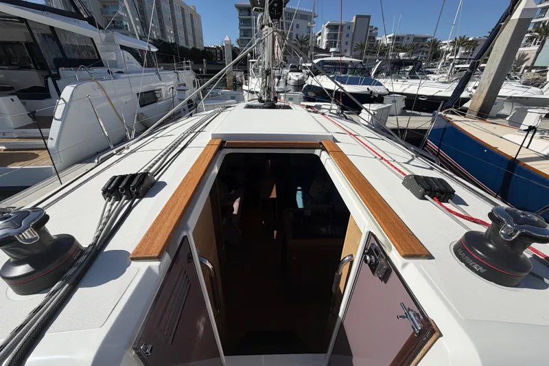 Slide: The Image of 2024 Jeanneau Sun Odyssey 349 sailboat docked at marina, showcasing deck and rigging. - 30