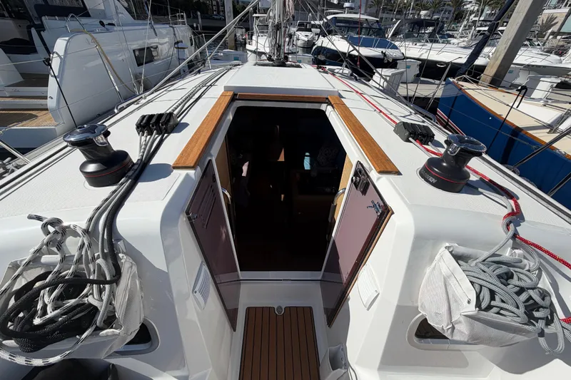 Slide: The Image of 2024 Jeanneau Sun Odyssey 349 sailboat deck with winches and ropes in marina. - 31