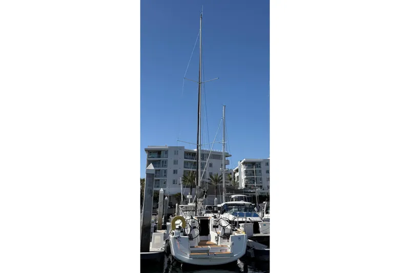 Slide: The Image of 2024 Jeanneau Sun Odyssey 349 sailboat docked at marina, clear blue sky background. - 36