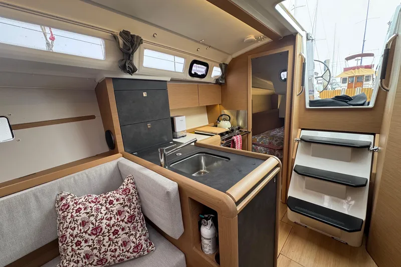 Slide: The Image of 2024 Jeanneau Sun Odyssey 349 interior with modern kitchen and cozy seating area. - 50