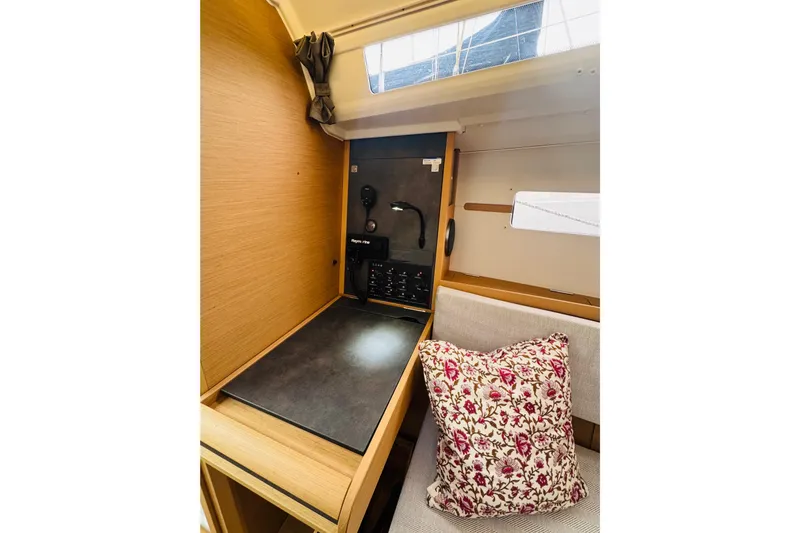Slide: The Image of 2024 Jeanneau Sun Odyssey 349 interior with navigation station and floral cushion. - 55