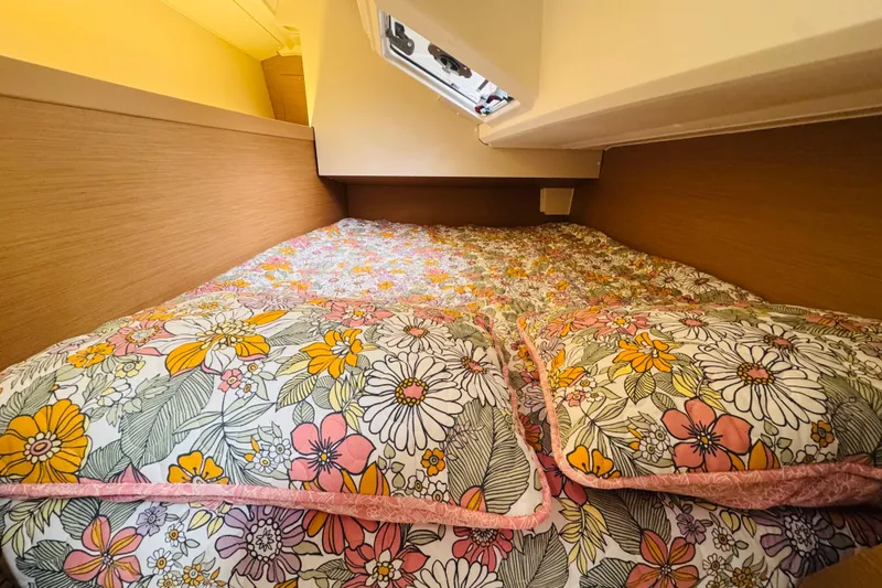 Slide: The Image of Cozy cabin bed in 2024 Jeanneau Sun Odyssey 349 with floral bedding. - 58